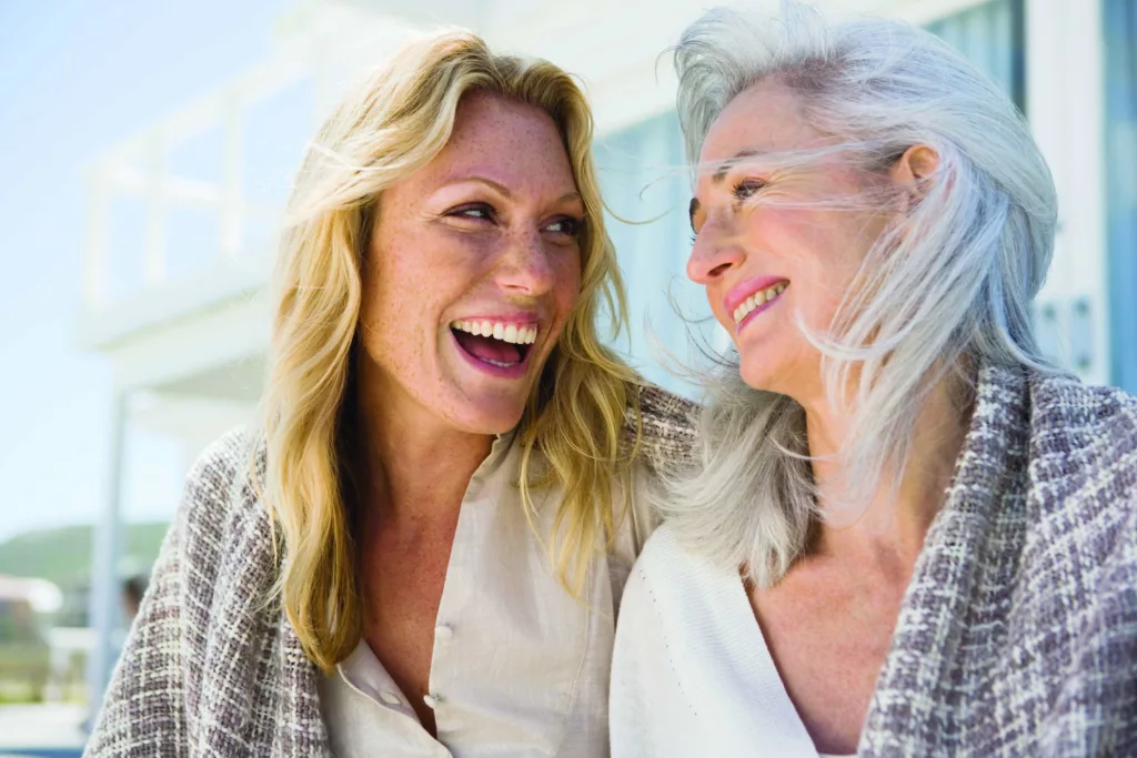 woman and older mother laugh together