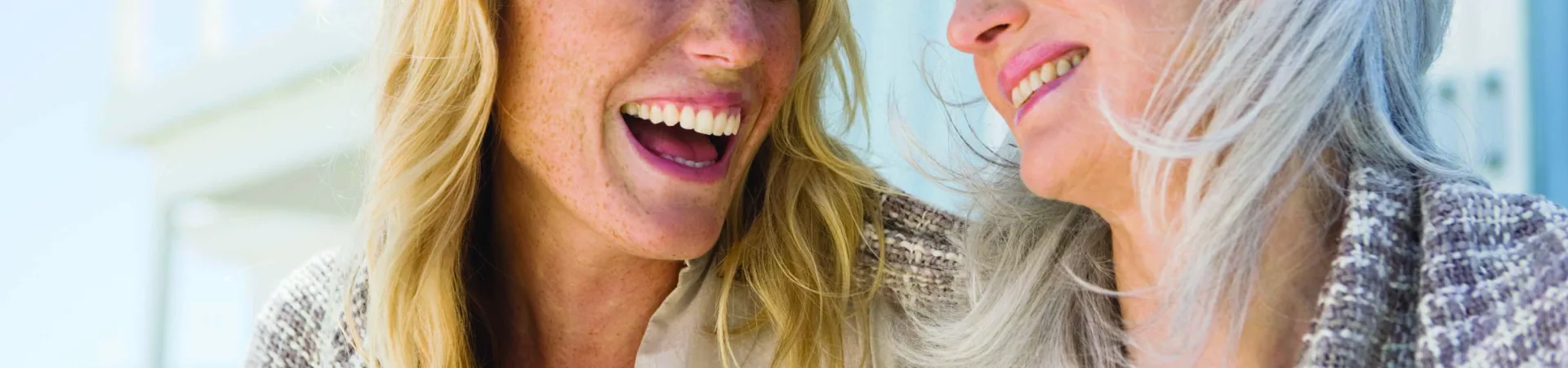woman and older mother laugh together