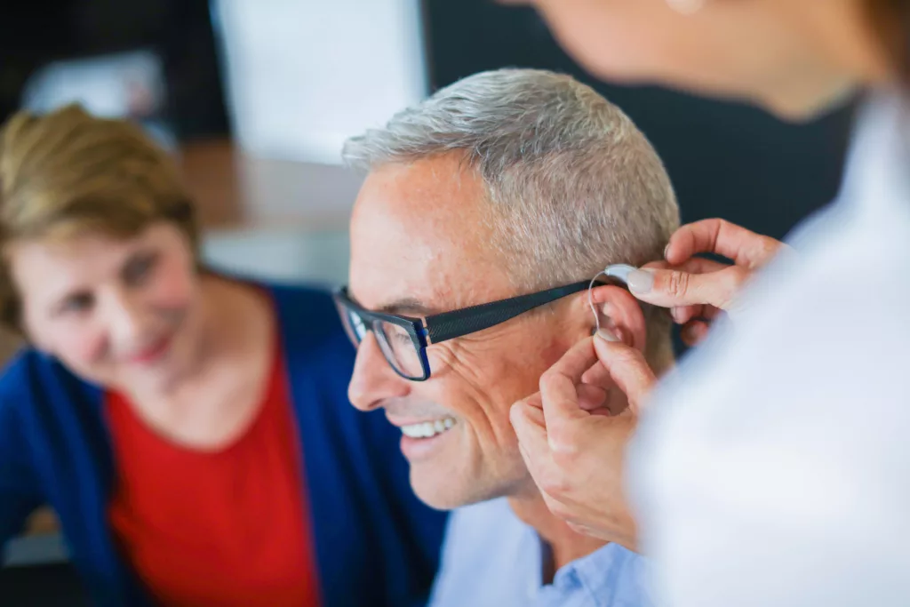 older man is fitted with first hearing aid