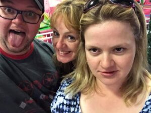 Barbara, an employee of ihear Australia, smiles for the camera with her son and daughter