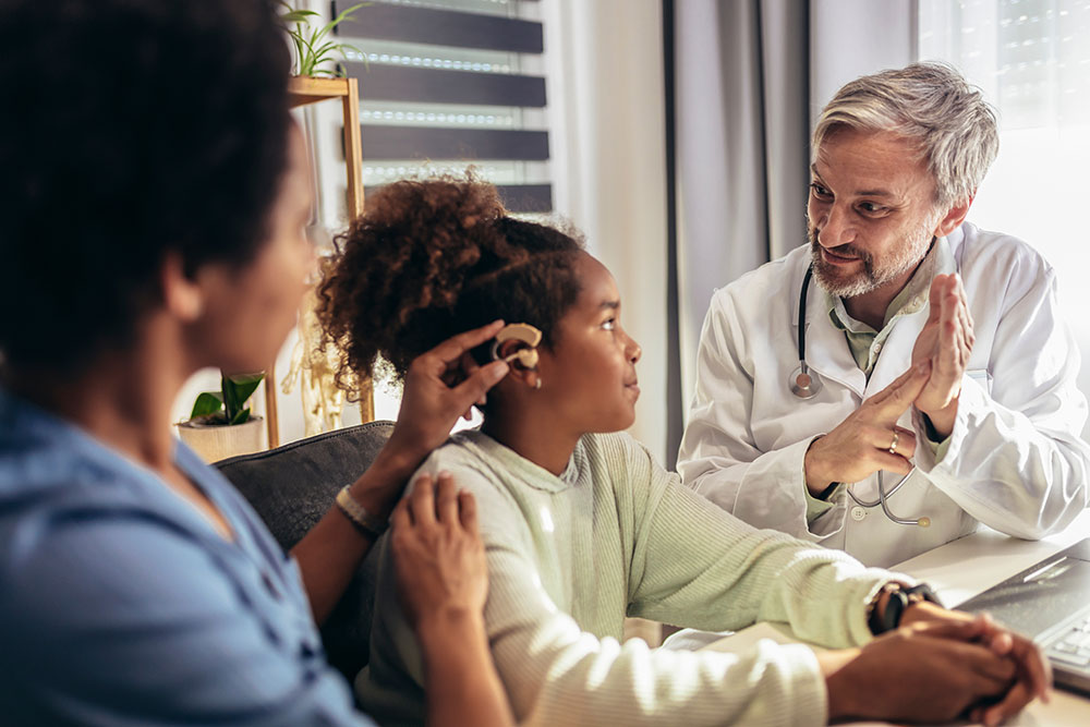 child being fitted for an assistive listening device during a hearing test